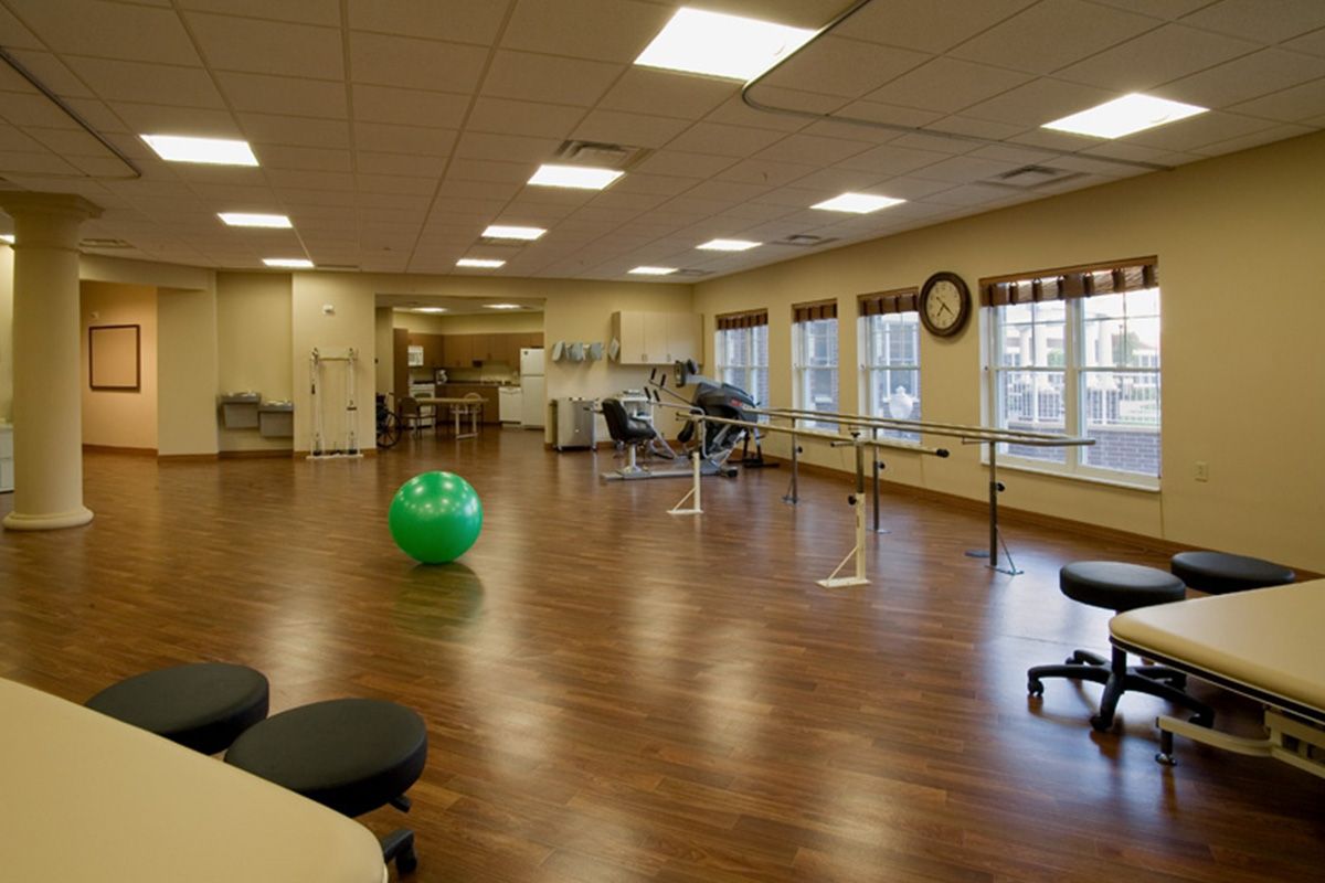 A spacious rehabilitation center with exercise equipment and therapy facilities.