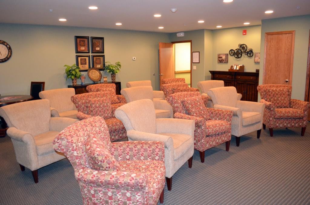 A cozy waiting room with several comfortable chairs arranged in rows.
