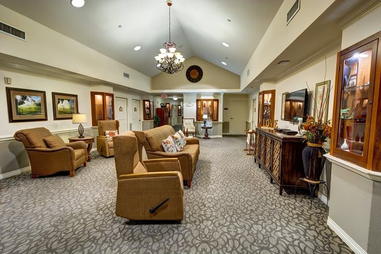 A cozy living room with comfortable seating, warm lighting, and decorative artwork.