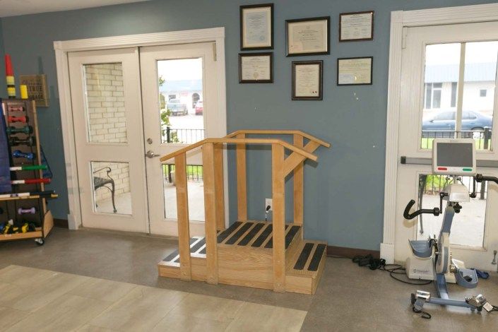 Wooden therapy stairs used for rehabilitation exercises in a clinic setting.