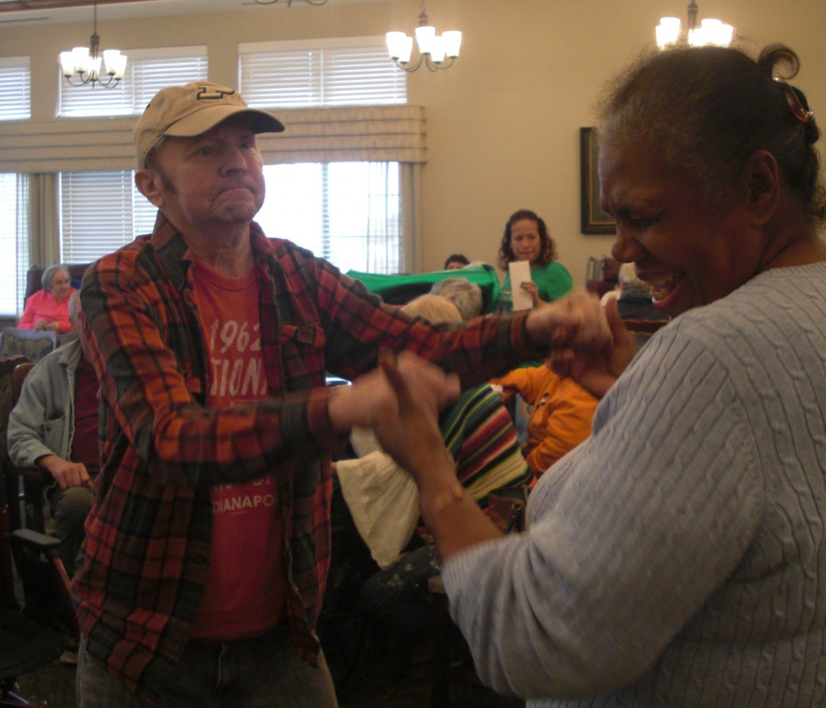 A joyful indoor dance scene with people enjoying a social event.
