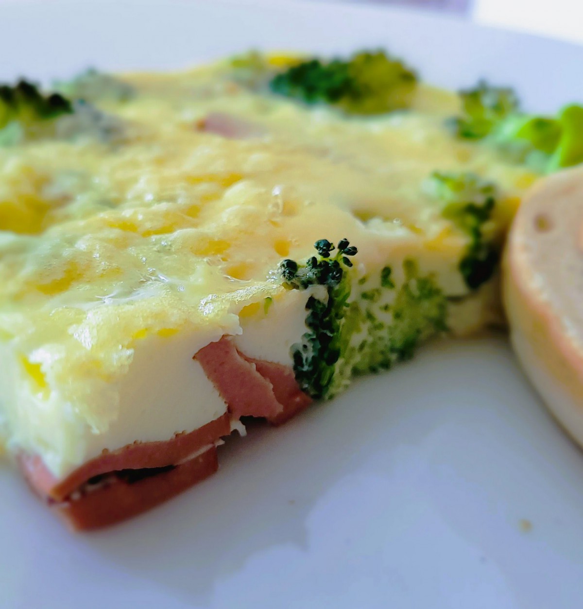 A delicious omelette with broccoli and cheese, served on a plate.