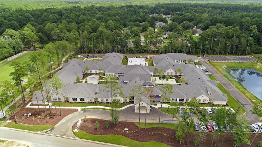 A serene aerial view of a modern residential housing complex surrounded by lush greenery.