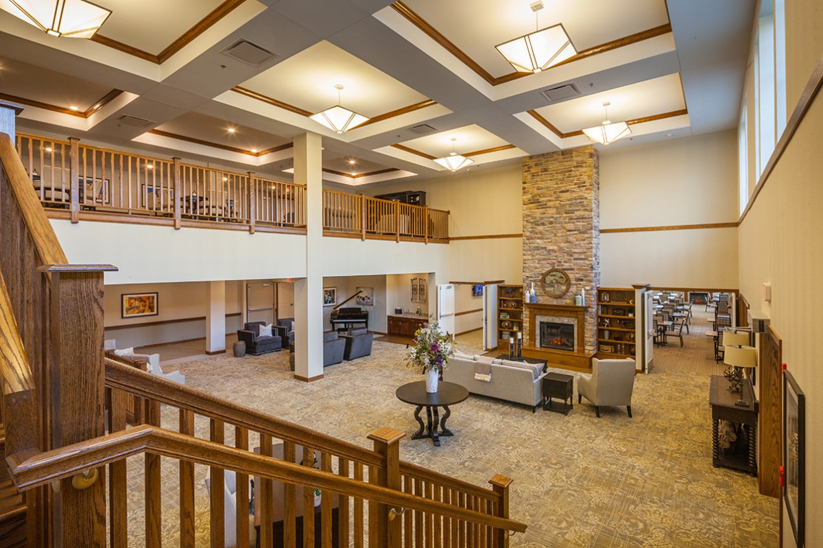 A spacious and elegantly decorated lobby with a fireplace, comfortable seating, and warm lighting.