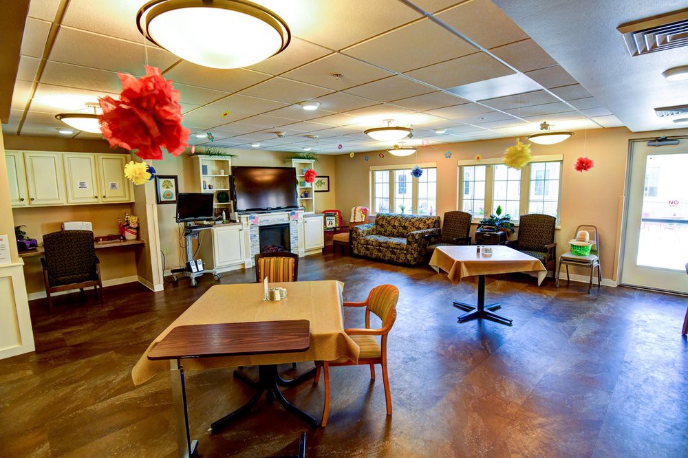 A cozy and well-decorated living room with various seating options and a television.