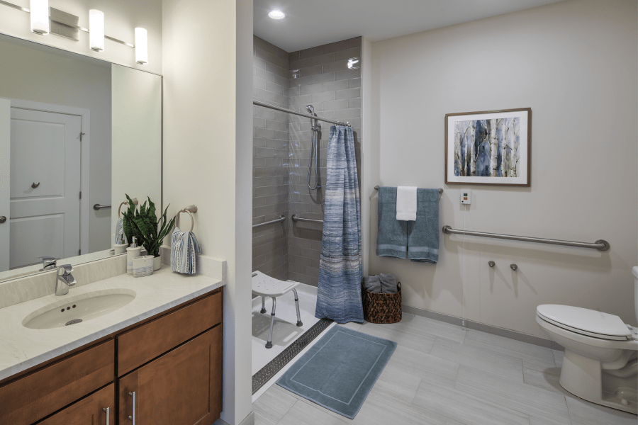 A modern bathroom with a shower area, sink, and tasteful decor.