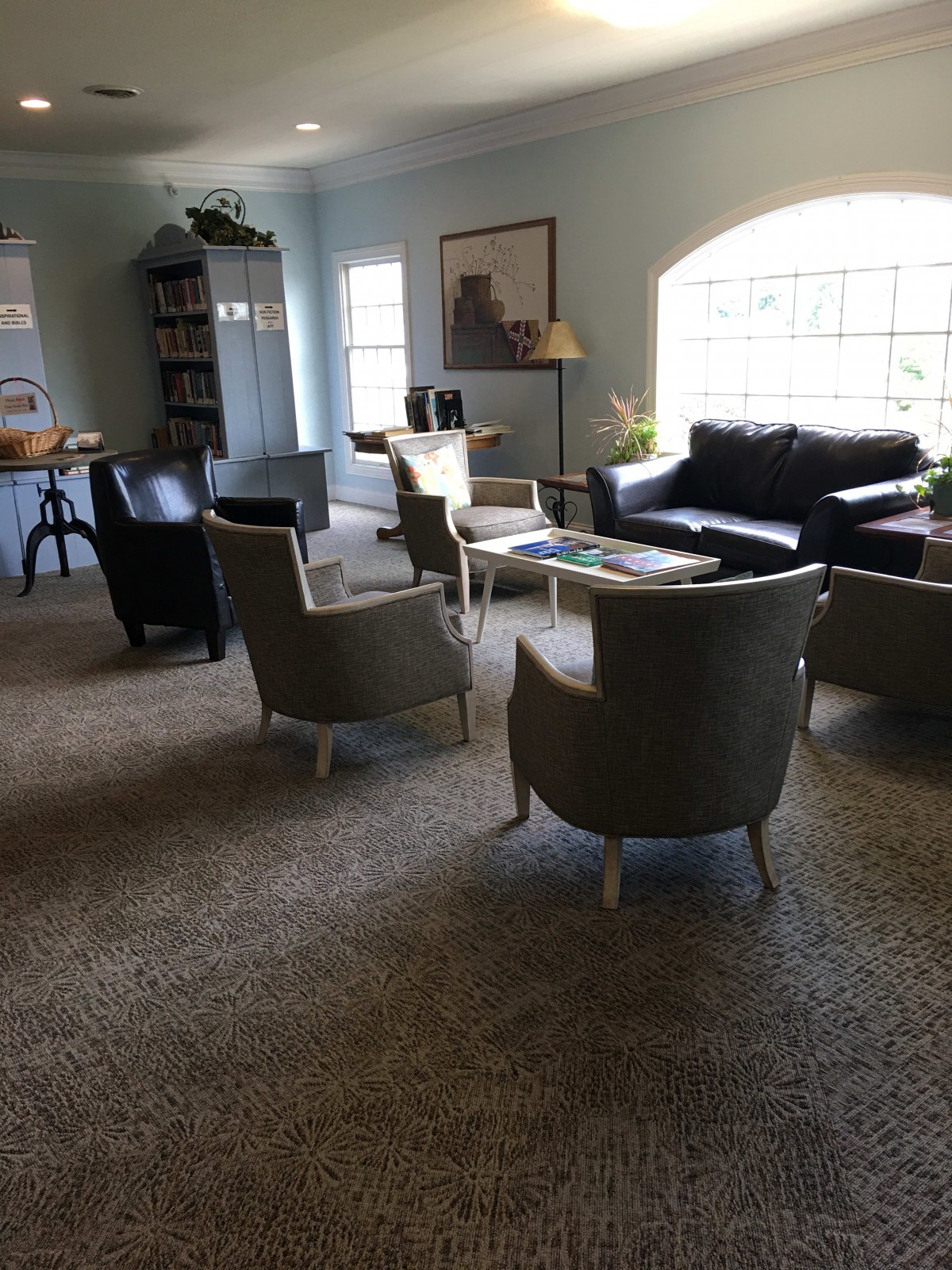 A spacious living room with comfortable seating and natural lighting.
