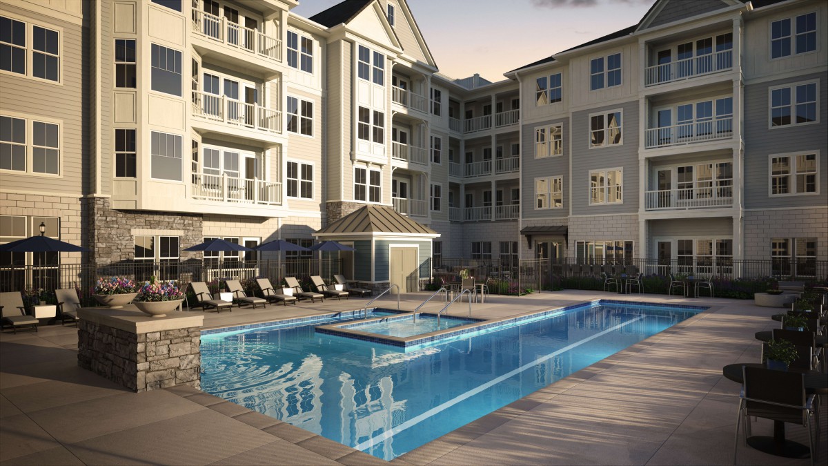 A modern apartment complex features a luxurious outdoor swimming pool surrounded by lounge chairs.