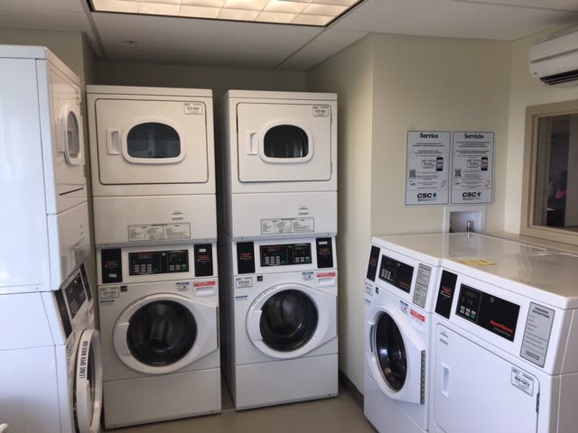 A laundry room with stacked washers and dryers.