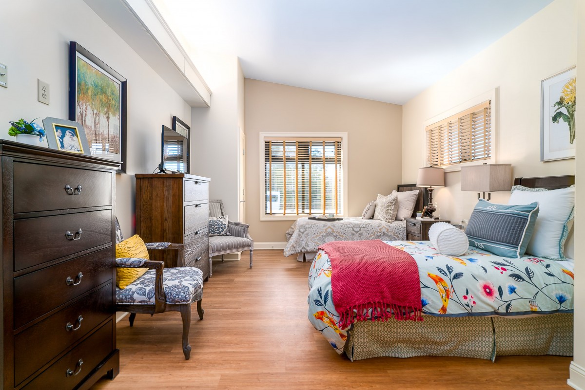 A cozy, well-decorated bedroom with vibrant bed linens and stylish furniture.