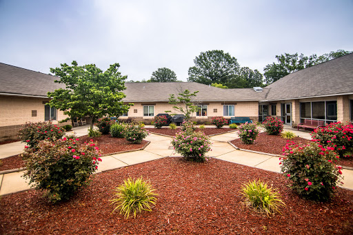 A well-maintained residential courtyard featuring beautiful landscaping and a vibrant garden.