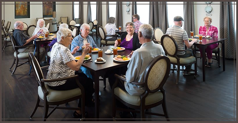 A group of seniors enjoying a meal together at a community dining area.