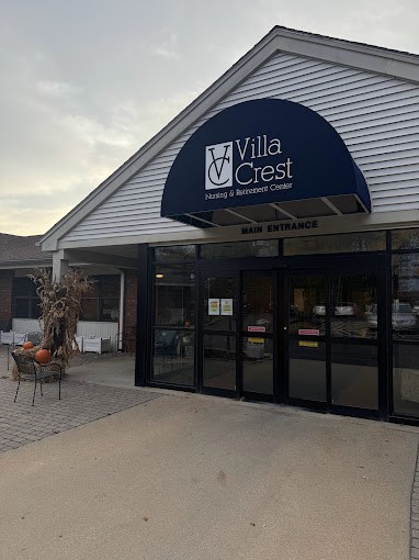 Entrance to Villa Crest with blue awning.