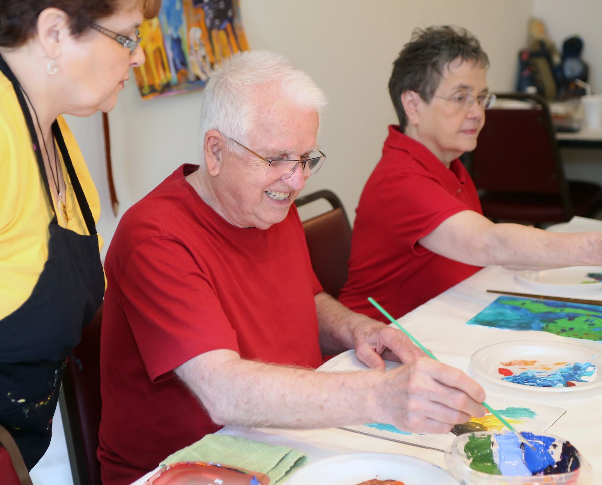 Seniors enjoying a painting session in an art class.