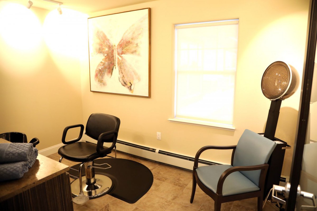 A cozy office space with chairs and artwork on the wall.