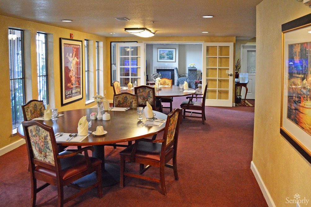 An elegantly furnished dining area with set tables and chairs.