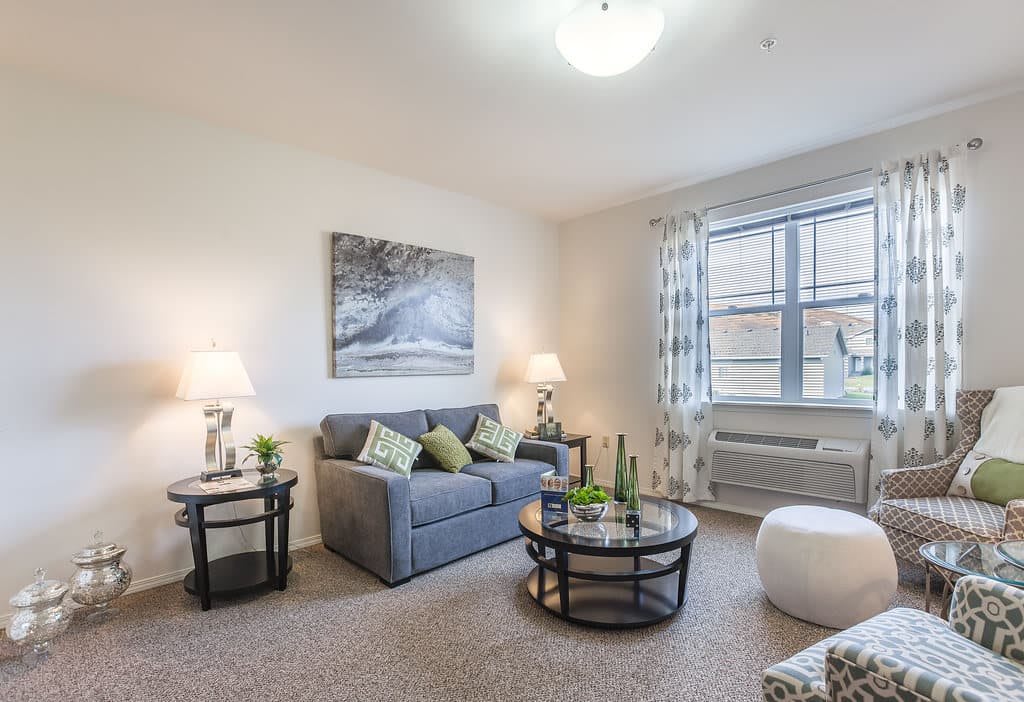 A cozy living room with a sofa, coffee table, and decorative elements.