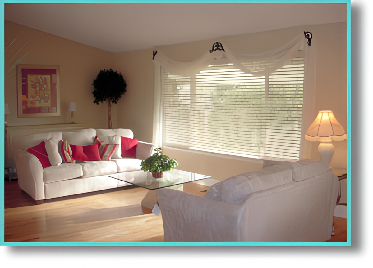 A cozy living room with a sofa, coffee table, and abundant natural light.