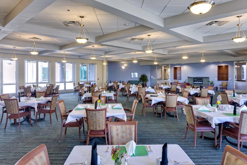 A spacious and elegantly decorated dining area with tables set for guests.
