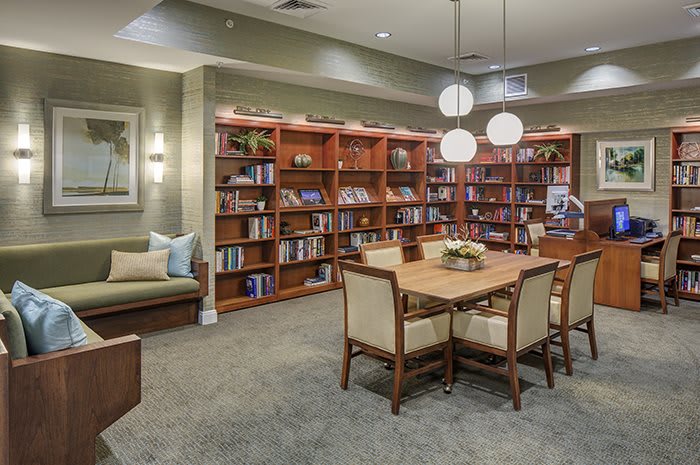 Cozy library with wooden bookshelves and a comfortable reading area.