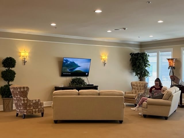 A quiet lobby with comfortable seating and a television.