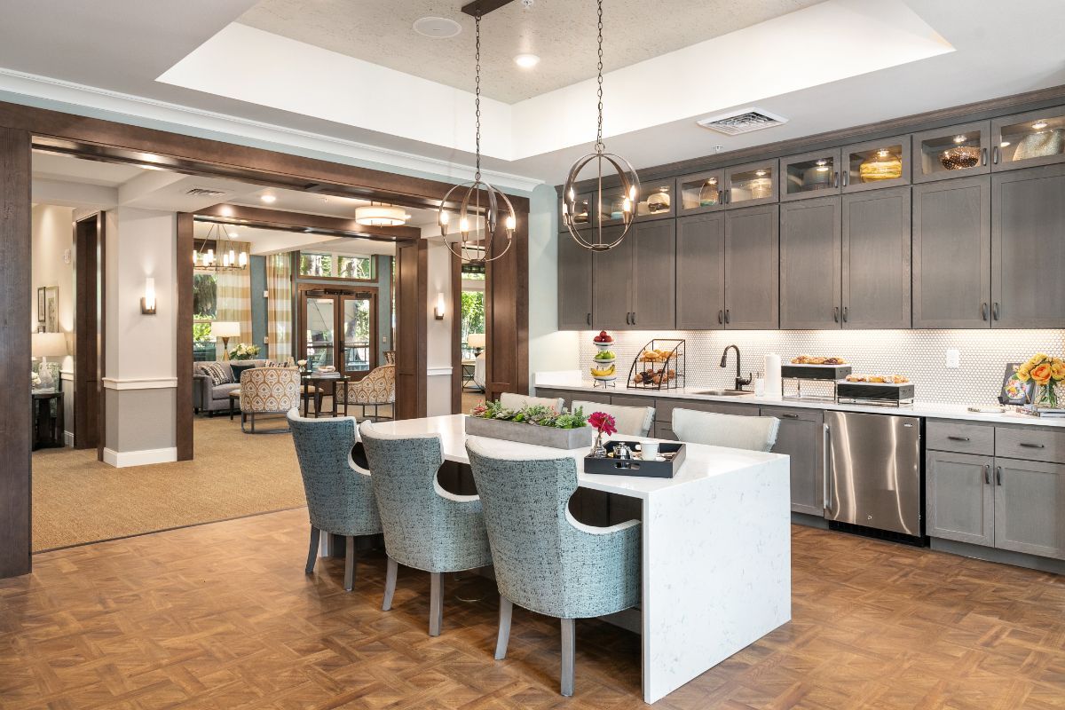 A modern kitchen and dining area with sleek design and stylish lighting.