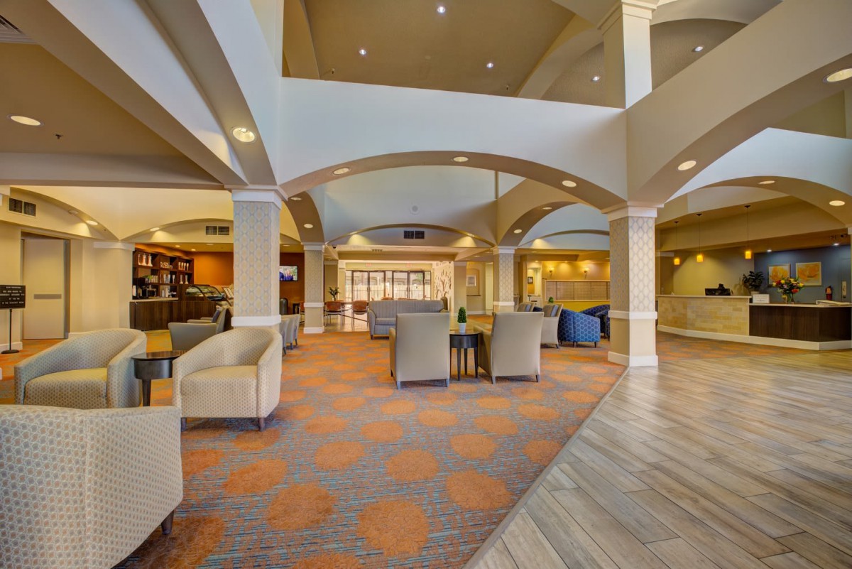 A modern hotel lobby with comfortable seating and elegant architectural elements.