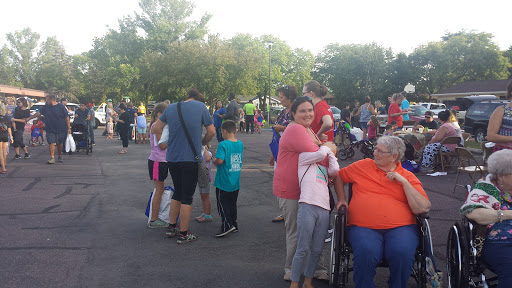 A lively community gathering with families and children enjoying the outdoor atmosphere.
