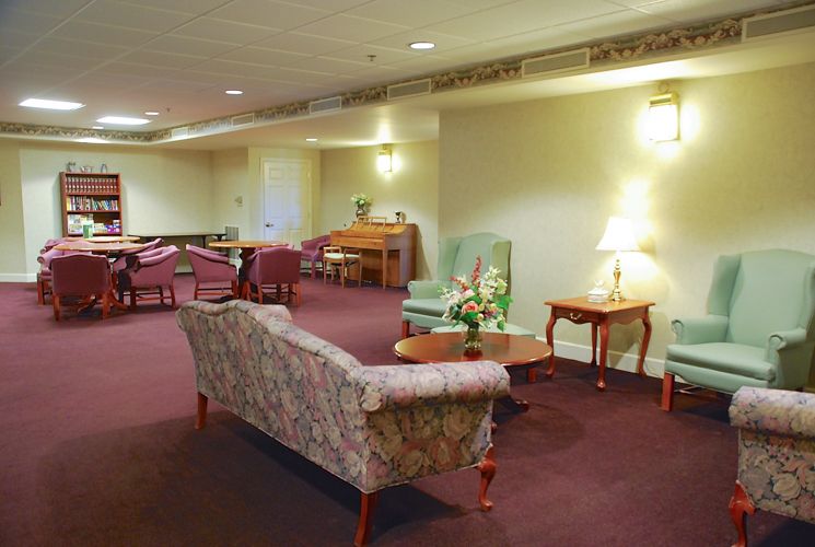 A well-furnished lobby area with sofas, chairs, tables, and soft lighting.