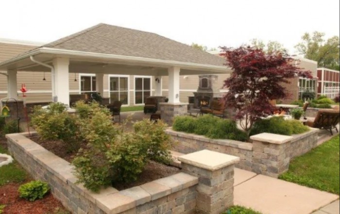 A residential house with a landscaped garden and patio area.