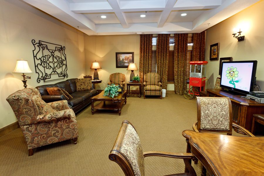 A cozy living room with comfortable seating, tasteful decor, and a popcorn machine.