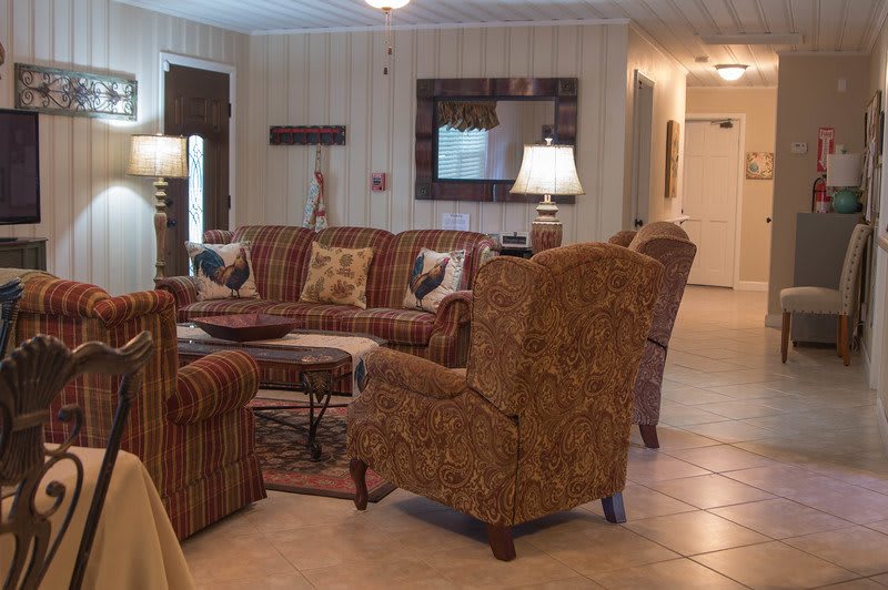 A cozy living room with patterned furniture and warm lighting.