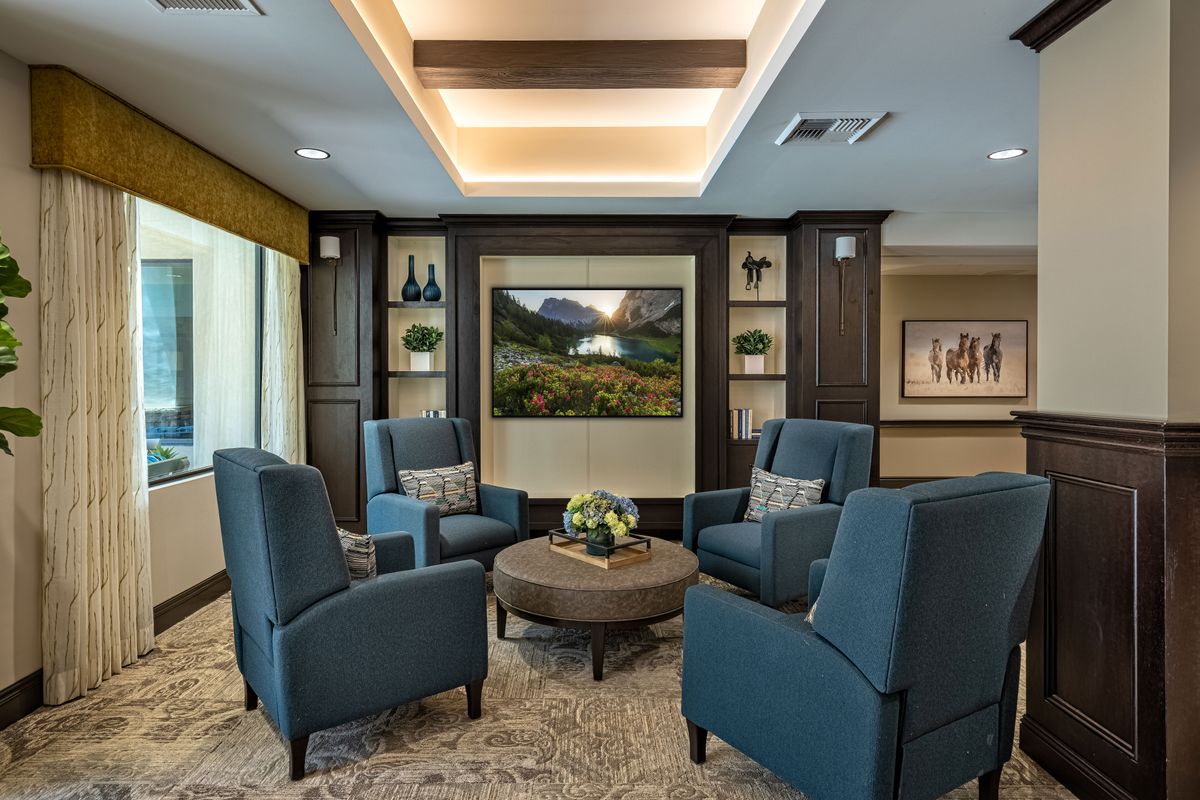 A comfortable lounge area with armchairs and a coffee table, elegantly decorated with modern interior design.