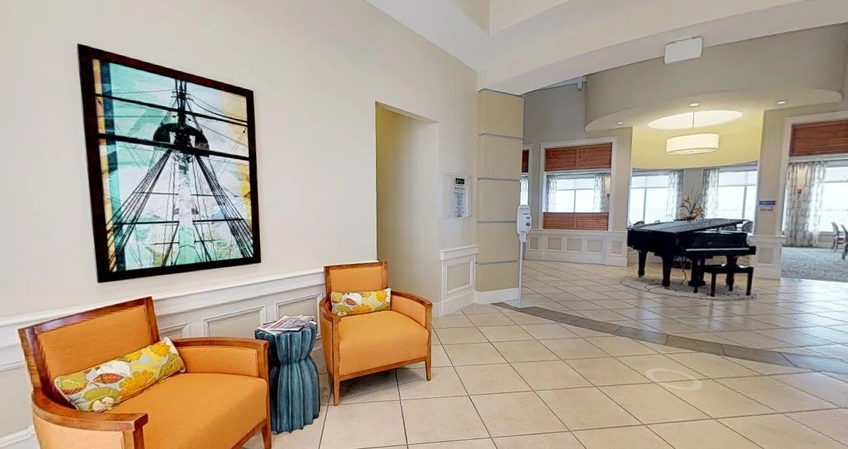 A modern lobby with comfortable seating and artwork on the wall.