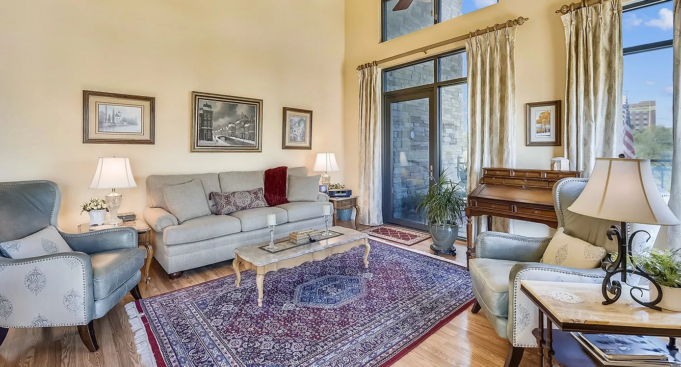 A cozy living room with a sofa, coffee table, and decorative rug.