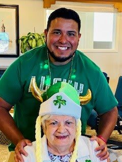 Two people enjoying a festive celebration with St. Patrick's Day attire.
