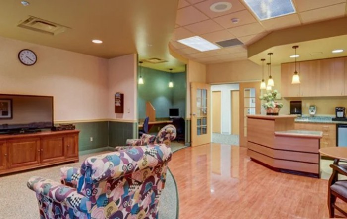 A cozy reception area with seating and a computer station.