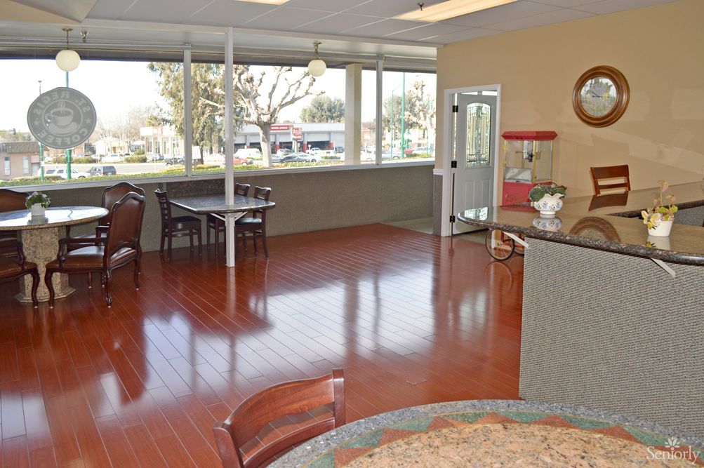 A well-lit lobby area with seating and large windows.
