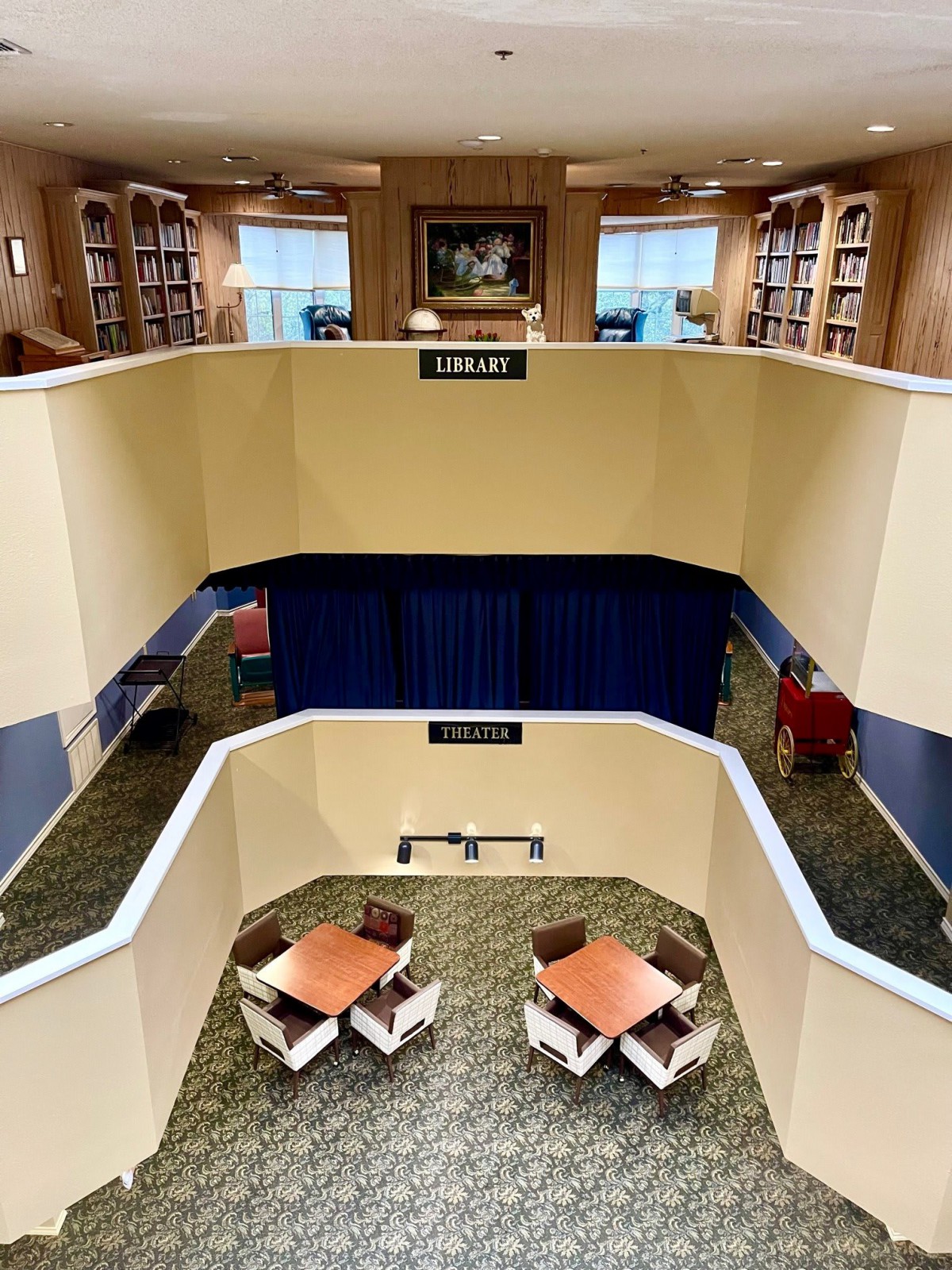 Two-story library interior with study tables and bookshelves.