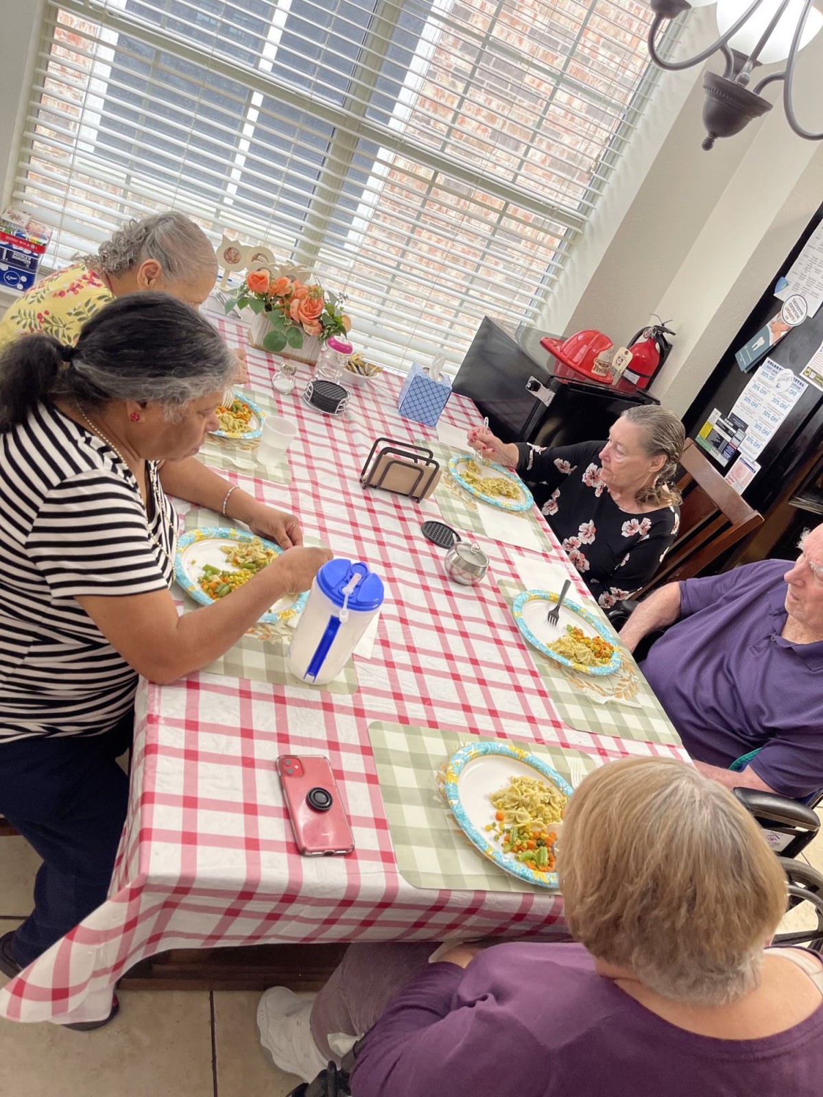 A group of people enjoying a meal together at a dining table.