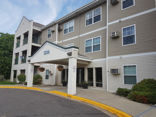 A view of a modern apartment building showcasing its entrance and surrounding area.