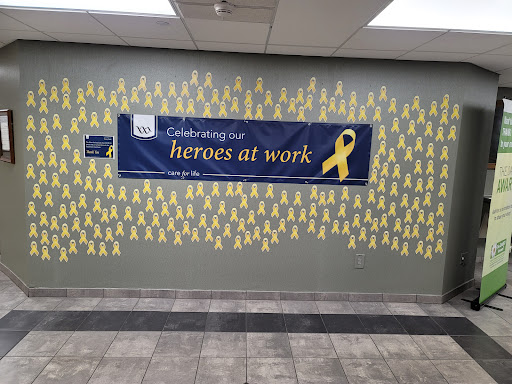 A vibrant display honoring 'Heroes at Work' with yellow ribbons adorning the wall.