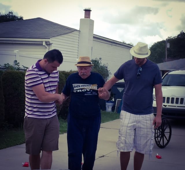 Three people walking together outside, showing support and friendship.