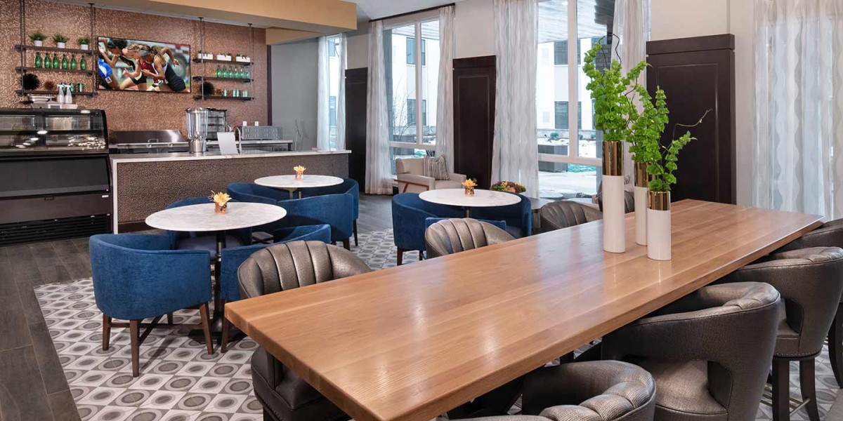 A modern cafe with stylish seating and wooden tables, featuring a cozy ambiance.