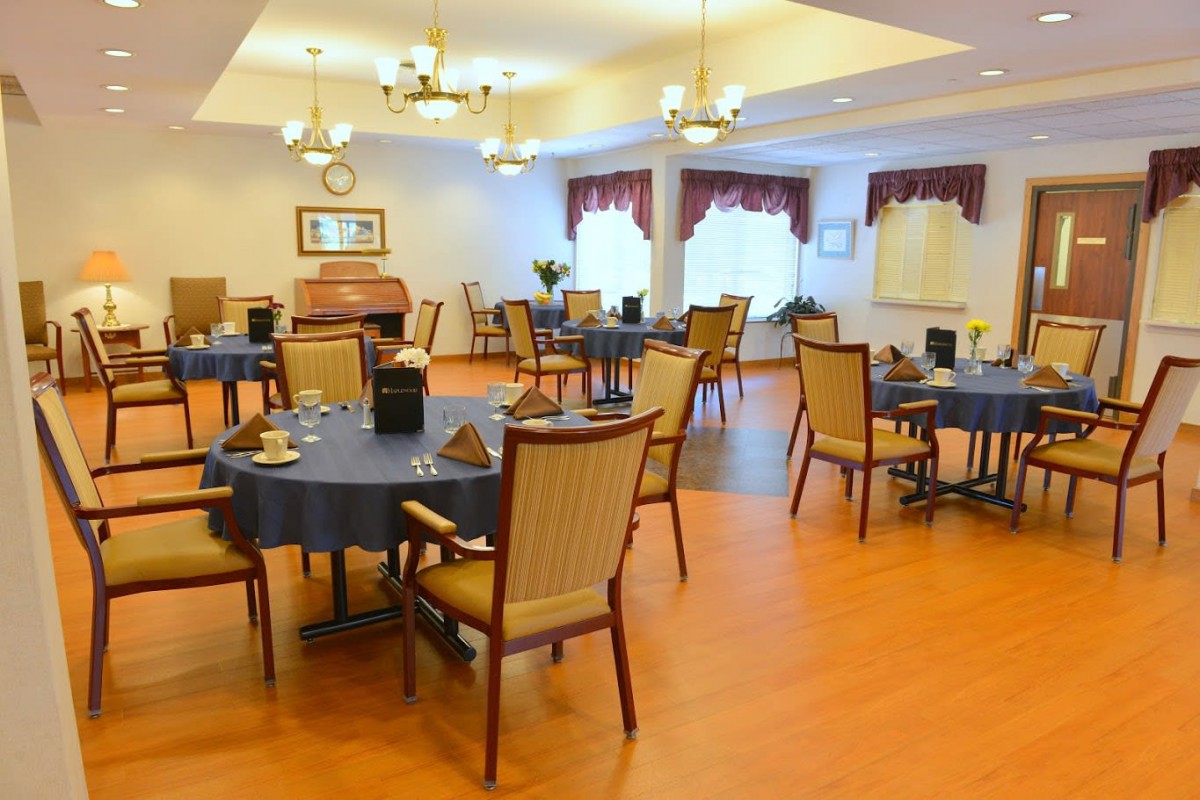 Elegant dining room with tables and chairs set for service.