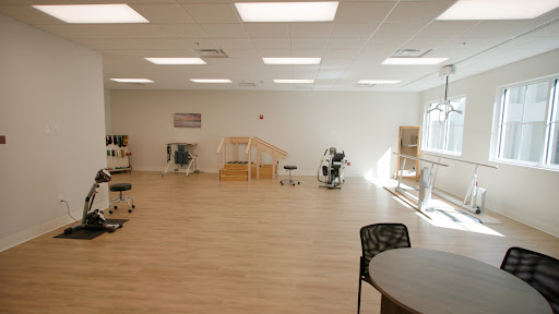 A bright and spacious therapy room designed for rehabilitation exercises.