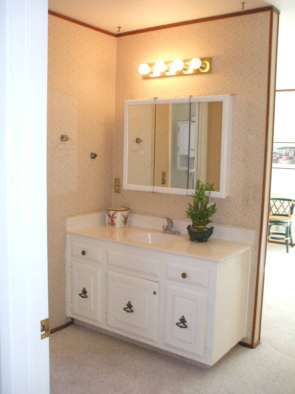 A bathroom vanity with a mirror, sink, and light fixture.