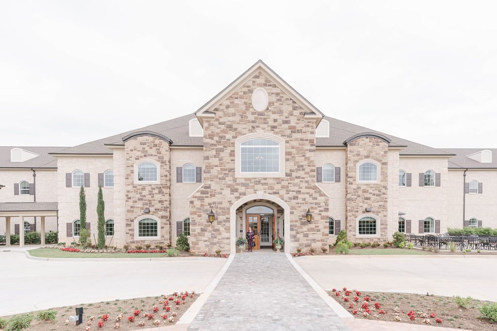 A large mansion with a stone facade and luxurious architectural design.