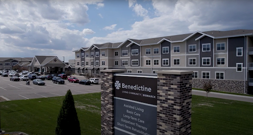 Exterior view of the Benedictine facility with a welcoming sign and residential apartments.