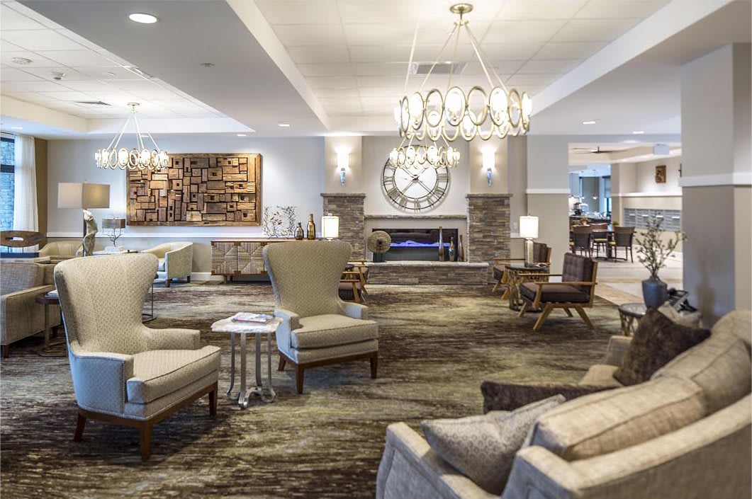 Elegant hotel lobby with comfortable seating and a modern fireplace.